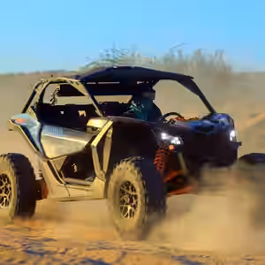 Orange and black UTV kicking up dust while driving through desert terrain road to candelaria  in Cabo San Lucas
