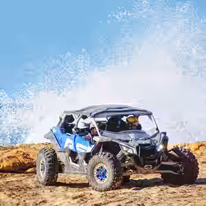 Can Am X3 Blue and black UTV buggy on sandy beach with ocean waves splashing in background, Baja California Sur